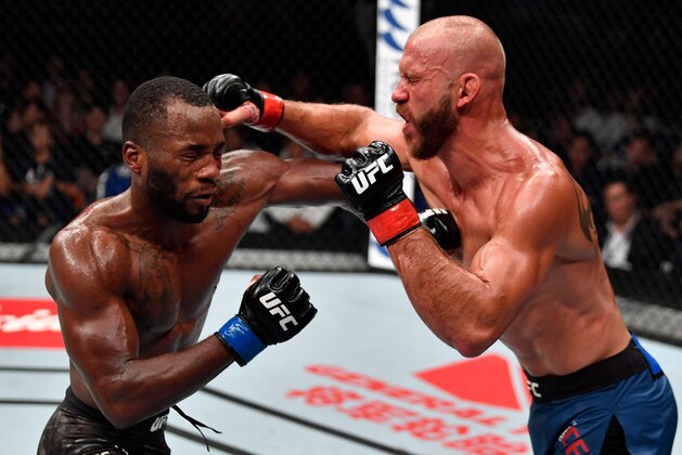 SINGAPORE - JUNE 23:  (R-L) Donald Cerrone and Leon Edwards of Jamaica trade punches in their welterweight bout during the UFC Fight Night event at the Singapore Indoor Stadium on June 23, 2018 in Singapore. (Photo by Jeff Bottari/Zuffa LLC/Zuffa LLC via Getty Images)