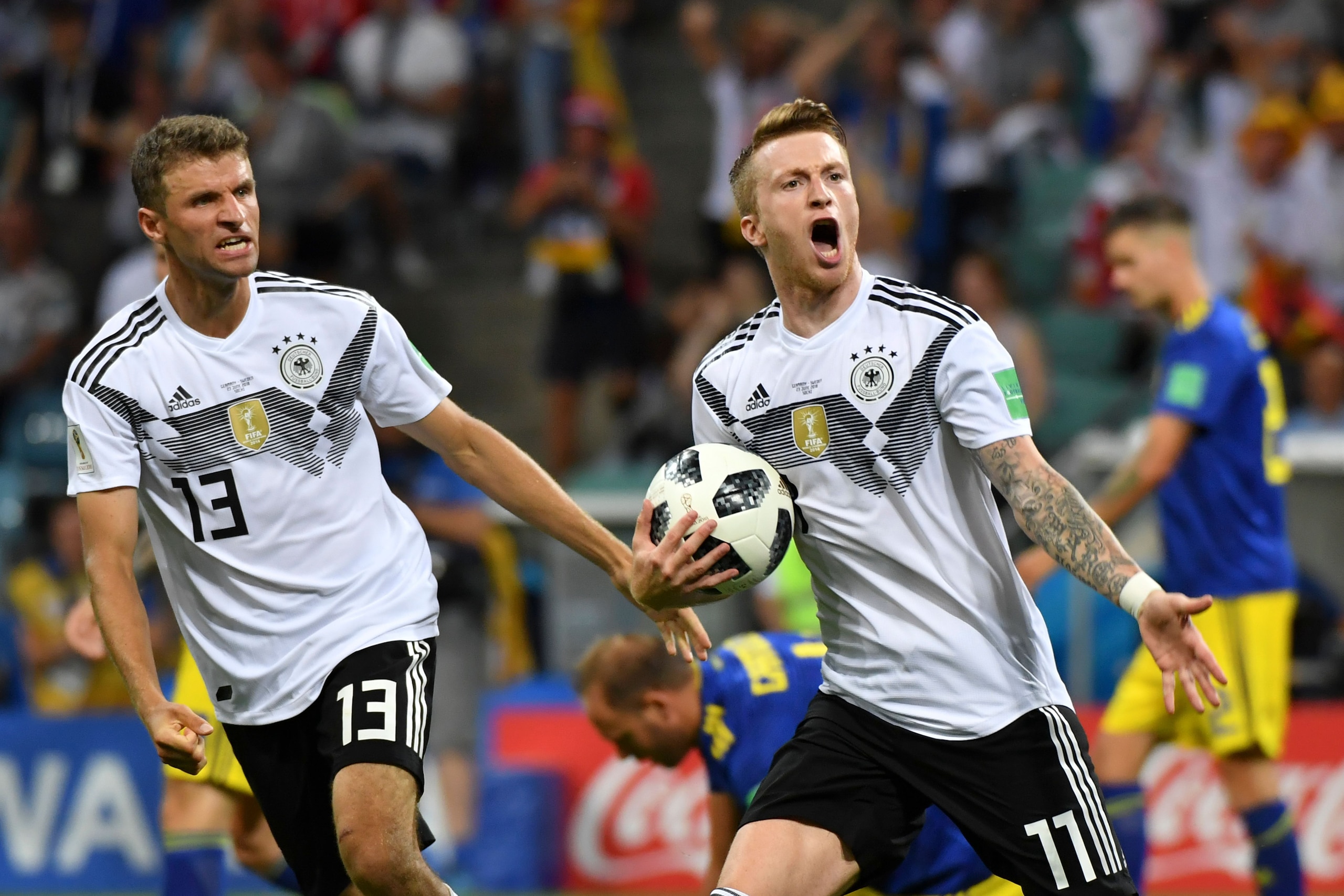 TOPSHOT - Germany's forward Marco Reus celebrates scoring the 1-1 goal with Germany's forward Thomas Mueller (L) during the Russia 2018 World Cup Group F football match between Germany and Sweden at the Fisht Stadium in Sochi on June 23, 2018. (Photo by Nelson Almeida / AFP) / RESTRICTED TO EDITORIAL USE - NO MOBILE PUSH ALERTS/DOWNLOADS        (Photo credit should read NELSON ALMEIDA/AFP/Getty Images)
