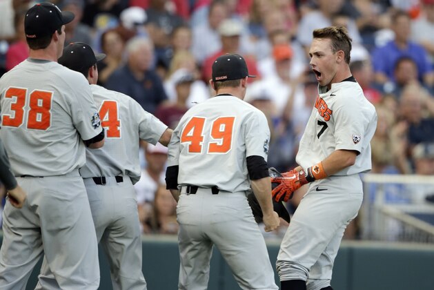 Oregon State's Tyler Malone (7) celebrates his three-run home run against Mississippi State in the third inning of an NCAA College World Series baseball elimination game in Omaha, Neb., Saturday, June 23, 2018. (AP Photo/Nati Harnik)