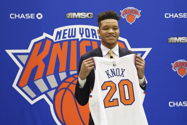 New York Knicks first round NBA Draft pick, Kevin Knox, poses with his jersey at the teams training facility Friday, June 22, 2018, in Tarrytown, N.Y.  (AP Photo/Kevin Hagen)