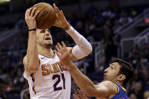 Phoenix Suns center Alex Len (21) shoots over Golden State Warriors center Zaza Pachulia in the second half during an NBA basketball game, Sunday, April 8, 2018, in Phoenix. The Warriors defeated the Suns 117-100. (AP Photo/Rick Scuteri)