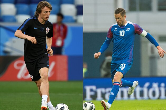 (COMBO) This combination of pictures created on June 24, 2018 shows Croatia's midfielder Luka Modric (L) at the Nizhny Novgorod Stadium on June 20, 2018, and Iceland's midfielder Gylfi Sigurdsson in Reykjavik, on June 7, 2018. - Iceland will play Croatia in their Russia 2018 World Cup Group D football match at the Rostov Arena in Rostov-On-Don on June 26, 2018. (Photos by Dimitar DILKOFF and Haraldur Gudjonsson / AFP)        (Photo credit should read DIMITAR DILKOFF,HARALDUR GUDJONSSON/AFP/Getty Images)
