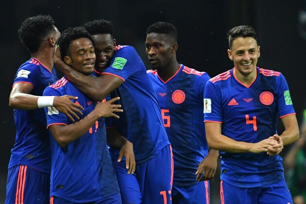 Colombia's forward Juan Cuadrado (2ndL) celebrates with teammates after scoring their third goal during the Russia 2018 World Cup Group H football match between Poland and Colombia at the Kazan Arena in Kazan on June 24, 2018. (Photo by SAEED KHAN / AFP) / RESTRICTED TO EDITORIAL USE - NO MOBILE PUSH ALERTS/DOWNLOADS        (Photo credit should read SAEED KHAN/AFP/Getty Images)