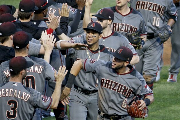 iArizona Diamondbacks' David Peralta, bottom right, celebrates with the rest of his teammates as they leave the field after defeating the Pittsburgh Pirates in a baseball game, Saturday, June 23, 2018, in Pittsburgh. The Diamondbacks won 7-2. (AP Photo/Keith Srakocic)