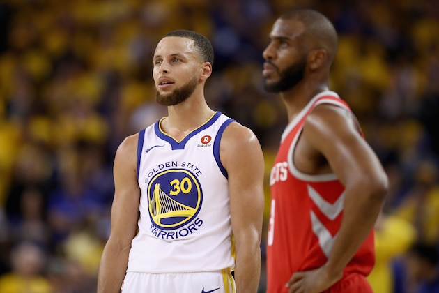 OAKLAND, CA - MAY 20:  Stephen Curry #30 of the Golden State Warriors stands next to Chris Paul #3 of the Houston Rockets during Game Three of the Western Conference Finals at ORACLE Arena on May 20, 2018 in Oakland, California. NOTE TO USER: User expressly acknowledges and agrees that, by downloading and or using this photograph, User is consenting to the terms and conditions of the Getty Images License Agreement.  (Photo by Ezra Shaw/Getty Images)