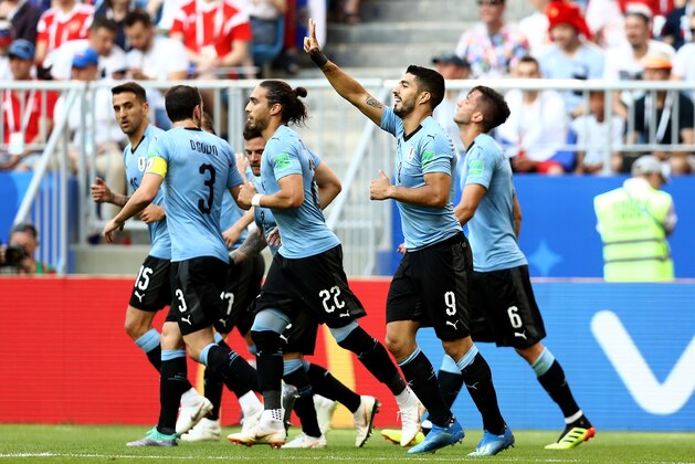 SAMARA, RUSSIA - JUNE 25:  Luis Suarez of Uruguay celebrates with teammate Diego Godin, Martin Caceres and Rodrigo Bentancur after scoring his team's first goal  during the 2018 FIFA World Cup Russia group A match between Uruguay and Russia at Samara Arena on June 25, 2018 in Samara, Russia.  (Photo by Maddie Meyer/Getty Images)