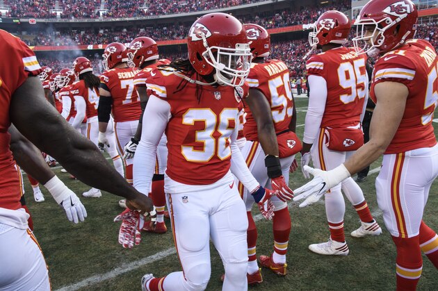 Kansas City Chiefs free safety Ron Parker (38) is greeted onto the field by teammates prior to the start of their NFL wild-card playoff game in Kansas City, Mo., Saturday, Jan. 6, 2018. (AP Photo/Reed Hoffmann)