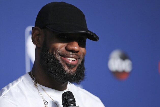 Cleveland Cavaliers forward LeBron James smiles during a news conference following Game 4 of basketball's NBA Finals against the Golden State Warriors, early Saturday, June 9, 2018, in Cleveland. The Warriors defeated the Cavaliers 108-85 to sweep the series and take the title. (AP Photo/Carlos Osorio)