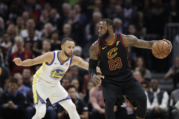 Cleveland Cavaliers' LeBron James is defended by Golden State Warriors' Stephen Curry in the first half of Game 3 of basketball's NBA Finals, Wednesday, June 6, 2018, in Cleveland. (AP Photo/Tony Dejak)