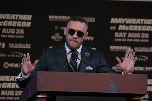 MMA fighter Connor Mcgregor gestures during a media press conference with boxer Floyd Mayweather Jr. (out of frame) on August 23, 2017 at the MGM Grand in Las Vegas, Nevada. 
Mayweather, the 40-year-old undefeated former welterweight boxing champion, has been lured out of retirement to face McGregor, a star of mixed martial arts' Ultimate Fighting Championship. The two men meet in a 12-round contest under boxing rules on August 26th that is tipped to become the richest fight in history.
 / AFP PHOTO / John Gurzinski        (Photo credit should read JOHN GURZINSKI/AFP/Getty Images)