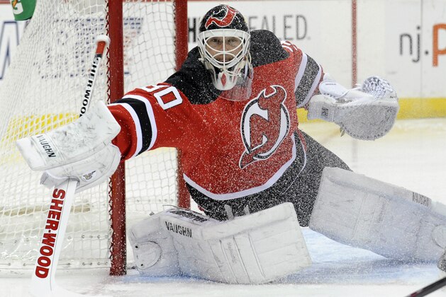 New Jersey Devils goaltender Martin Brodeur deflects the puck during the first period of an NHL hockey game against the Detroit Red Wings Tuesday, March 4, 2014, in Newark, N.J. (AP Photo/Bill Kostroun)