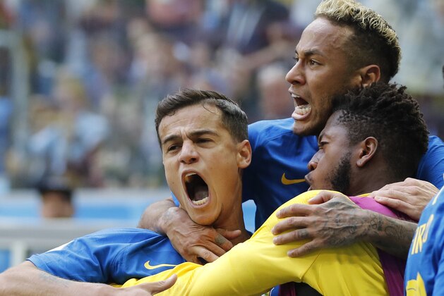 Brazil's Philippe Coutinho, left, celebrates scoring his side's opening goal with Neymar, top, and teammates during the group E match between Brazil and Costa Rica at the 2018 soccer World Cup in the St. Petersburg Stadium in St. Petersburg, Russia, Friday, June 22, 2018. Brazil won 2-0. (AP Photo/Petr David Josek)