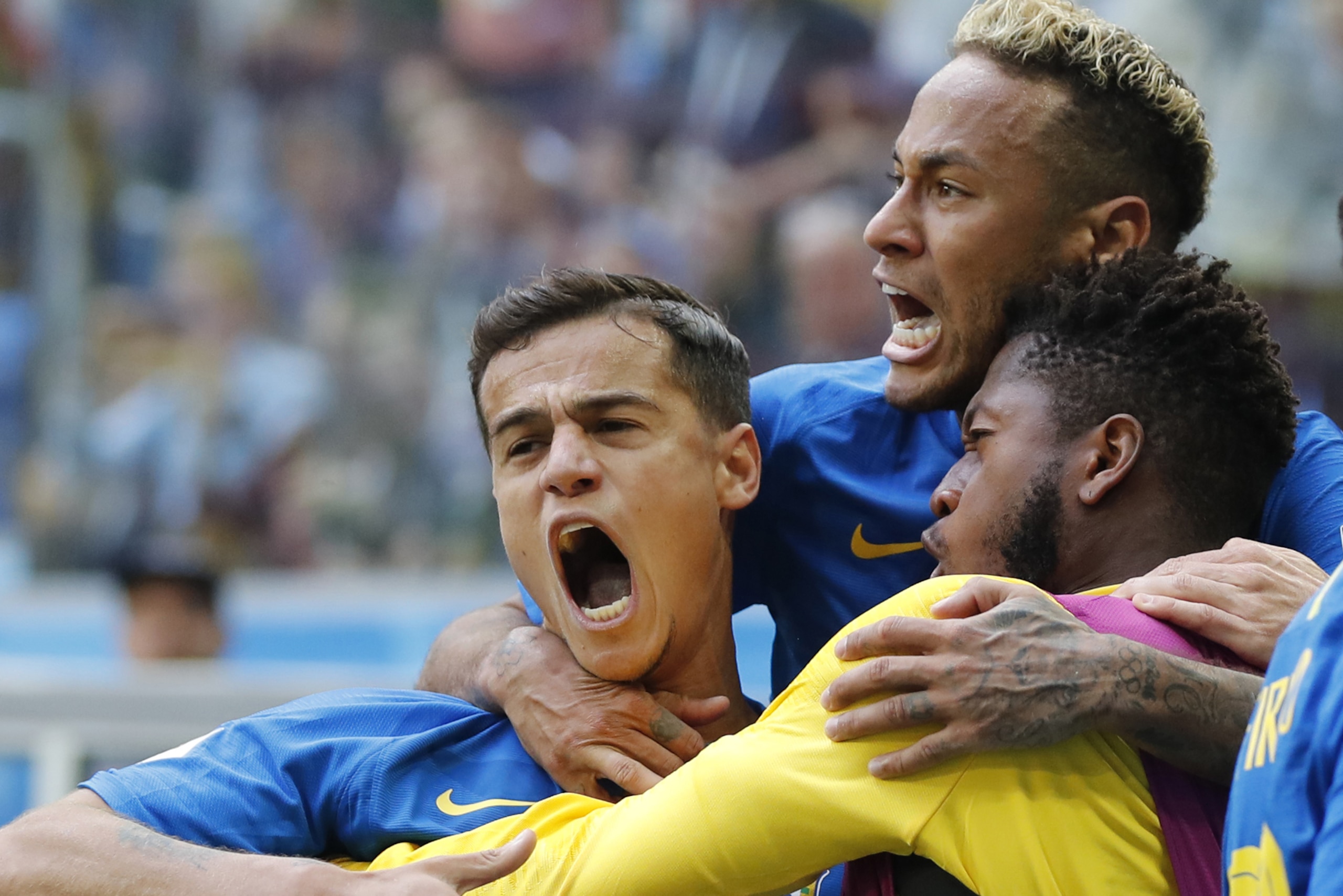 Brazil's Philippe Coutinho, left, celebrates scoring his side's opening goal with Neymar, top, and teammates during the group E match between Brazil and Costa Rica at the 2018 soccer World Cup in the St. Petersburg Stadium in St. Petersburg, Russia, Friday, June 22, 2018. Brazil won 2-0. (AP Photo/Petr David Josek)