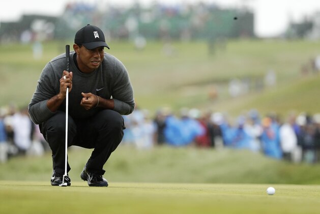 Tiger Woods lines up a putt on the first green during the second round of the U.S. Open Golf Championship, Friday, June 15, 2018, in Southampton, N.Y. (AP Photo/Frank Franklin II)