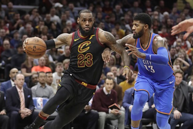 Cleveland Cavaliers' LeBron James (23) drives against Oklahoma City Thunder's Paul George (13) in the first half of an NBA basketball game, Saturday, Jan. 20, 2018, in Cleveland. (AP Photo/Tony Dejak)