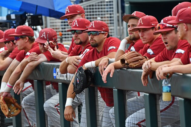 OMAHA, NE - JUNE 26: Arkansas Razorbacks players look on from the dugout, while the Oregon State Beavers take batting practice, prior to game one of the College World Series Championship Series on June 26, 2018 at TD Ameritrade Park in Omaha, Nebraska.  (Photo by Peter Aiken/Getty Images)