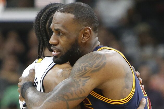 SAN ANTONIO,TX - MARCH 27:  LeBron James #23 of the Cleveland Cavaliers greets Kawhi Leonard #2 of the San Antonio Spurs  before the start of the game at AT&T Center on March 27, 2017 in San Antonio, Texas.  NOTE TO USER: User expressly acknowledges and agrees that , by downloading and or using this photograph, User is consenting to the terms and conditions of the Getty Images License Agreement. (Photo by Ronald Cortes/Getty Images)