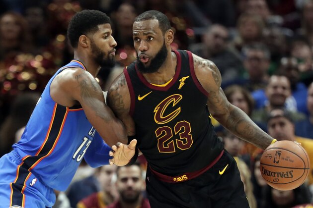 Cleveland Cavaliers' LeBron James, right, drives past Oklahoma City Thunder's Paul George in the second half of an NBA basketball game, Saturday, Jan. 20, 2018, in Cleveland. (AP Photo/Tony Dejak)