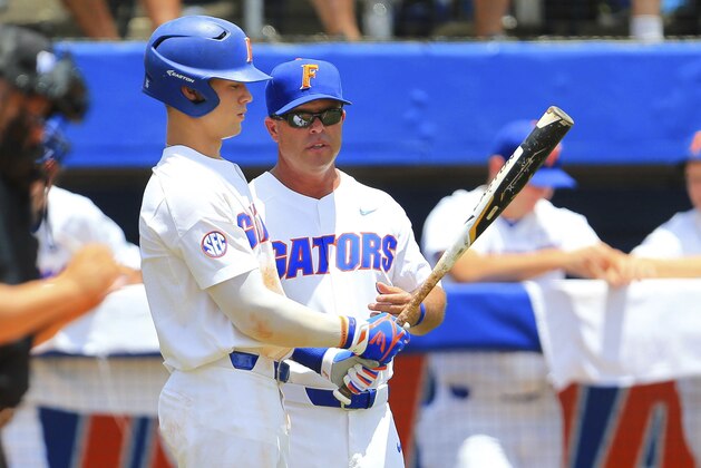 Florida outfielder Wil Dalton talks with head coach Kevin O'Sullivan against Auburn during an NCAA Super Regional college baseball game Saturday, June 9, 2018, in Gainesville, Fla. Florida defeated Auburn 8-2. (AP Photo/Matt Stamey)