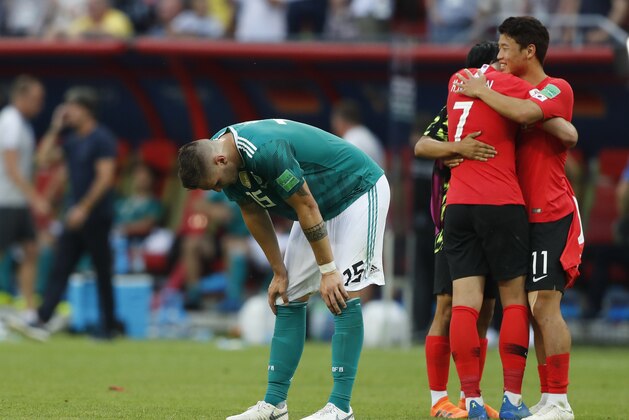 Germany's Niklas Suele, left, is dejected as South Korea's Son Heung-min, right, celebrates after the group F match between South Korea and Germany, at the 2018 soccer World Cup in the Kazan Arena in Kazan, Russia, Wednesday, June 27, 2018. South Korea won the match 2-0. (AP Photo/Frank Augstein)