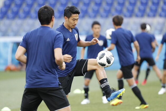 Japan's players warm up during the Japan's official training on the eve of the group H match between Poland and Japan at the Volgograd Arena the 2018 soccer World Cup in Volgograd, Russia, Wednesday, June 27, 2018. (AP Photo/Eugene Hoshiko)