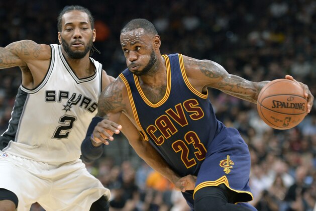 Cleveland Cavaliers forward LeBron James (23) drives against San Antonio Spurs forward Kawhi Leonard during the first half of an NBA basketball game, Monday, March 27, 2017, in San Antonio. (AP Photo/Darren Abate)
