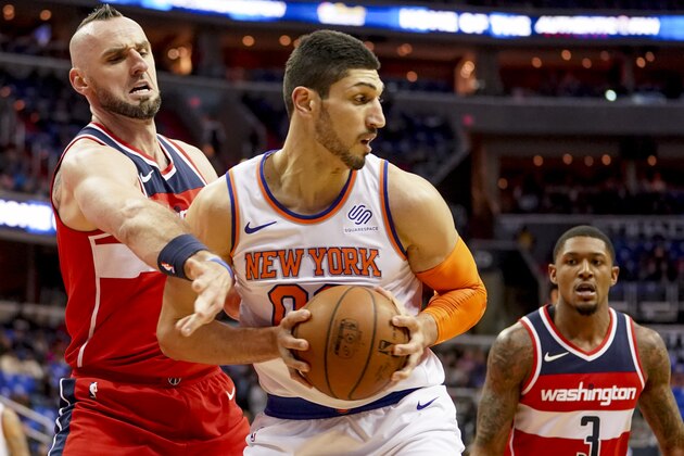 Washington Wizards center Marcin Gortat (13) tries to steal the ball from New York Knicks center Enes Kanter (00) in the first half of an NBA basketball game, Sunday, March 25, 2018, in Washington. (AP Photo/Andrew Harnik) Washington Wizards center Marcin Gortat (13) tries to steal the ball from New York Knicks center Enes Kanter (00) in the first half of an NBA basketball game, Sunday, March 25, 2018, in Washington. (AP Photo/Andrew Harnik)