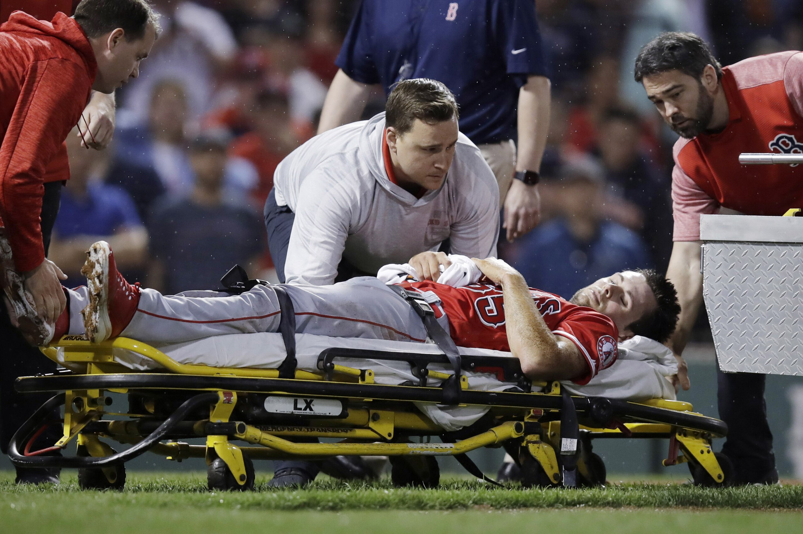 Los Angeles Angels' pitcher Jake Jewell is taken off the field on a stretcher after injuring his right ankle while covering home during the eighth inning against the Boston Red Sox in a baseball game at Fenway Park in Boston, Wednesday, June 27, 2018. (AP Photo/Charles Krupa)