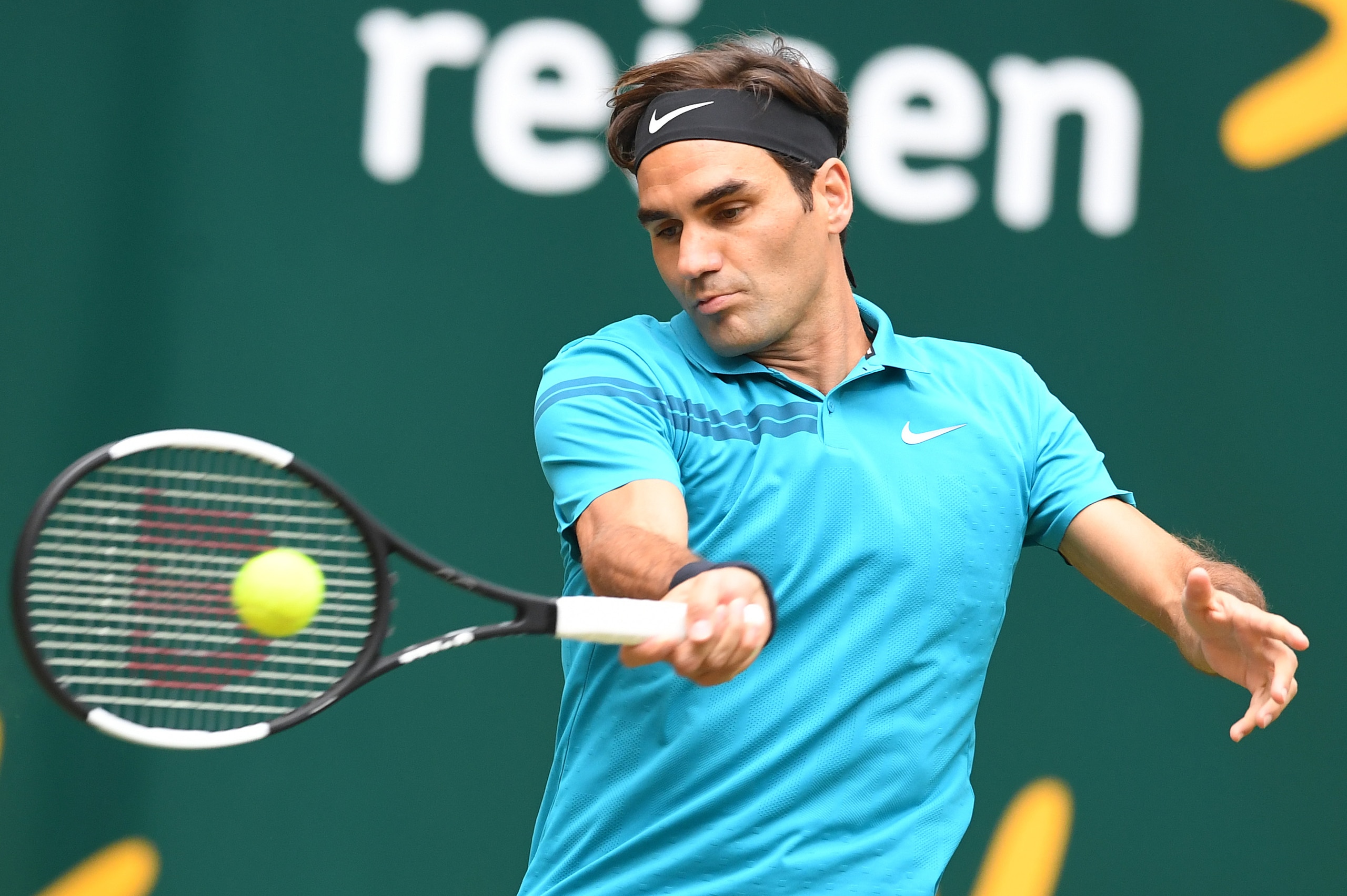 Roger Federer of Switzerland returns a ball to Borna Coric from Croatia during their final match at the ATP tennis tournament in Halle, western Germany, on June 24, 2018. (Photo by CARMEN JASPERSEN / AFP)        (Photo credit should read CARMEN JASPERSEN/AFP/Getty Images)