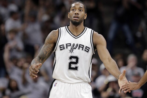San Antonio Spurs forward Kawhi Leonard (2) reaches out to a teammate after he score against the Oklahoma City Thunder during the first half in Game 1 of a second-round NBA basketball playoff series, Saturday, April 30, 2016, in San Antonio. (AP Photo/Eric Gay)