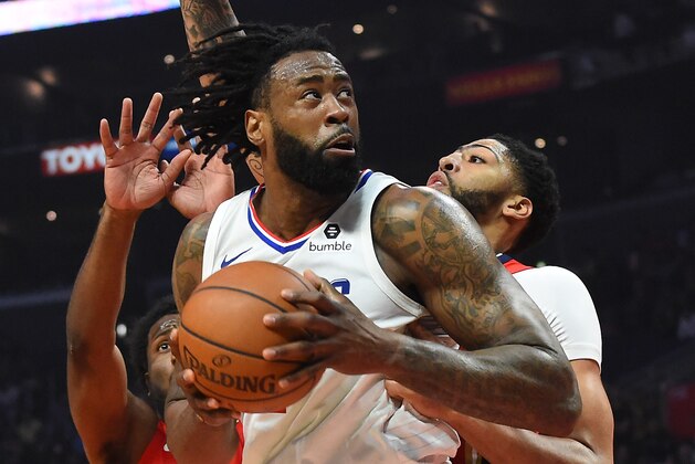 LOS ANGELES, CA - APRIL 09:  DeAndre Jordan #6 of the Los Angeles Clippers looks to shoot against Solomon Hill #44 and Anthony Davis #23 of the New Orleans Pelicans in the first half of the game at Staples Center on April 9, 2018 in Los Angeles, California.  NOTE TO USER: User expressly acknowledges and agrees that, by downloading and or using this photograph, User is consenting to the terms and conditions of the Getty Images License Agreement.  (Photo by Jayne Kamin-Oncea/Getty Images)