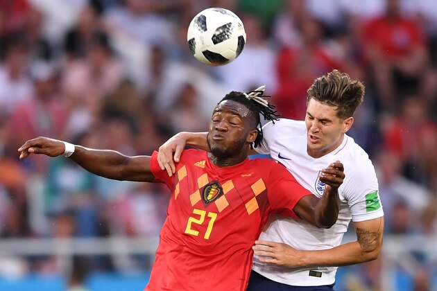 England's defender John Stones vies with Belgium's forward Michy Batshuayi (L) during the Russia 2018 World Cup Group G football match between England and Belgium at the Kaliningrad Stadium in Kaliningrad on June 28, 2018. (Photo by OZAN KOSE / AFP) / RESTRICTED TO EDITORIAL USE - NO MOBILE PUSH ALERTS/DOWNLOADS        (Photo credit should read OZAN KOSE/AFP/Getty Images)