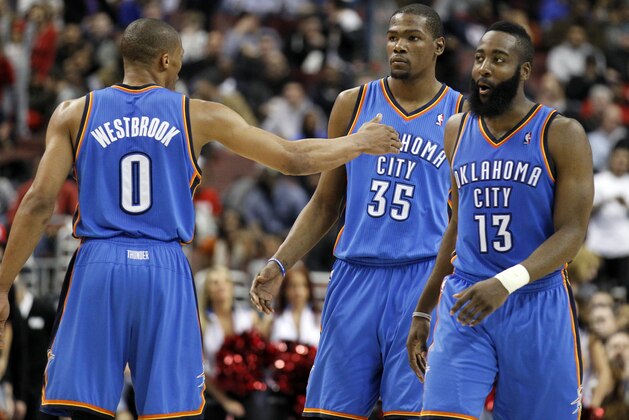 Oklahoma City Thunder's Russell Westbrook, left, reacts with teammates Kevin Durant (35) and James Harden (13) near the end of the first half of an NBA basketball game with the Philadelphia 76ers, Wednesday, Feb. 29, 2012, in Philadelphia. The Thunder won 92-88. (AP Photo/Alex Brandon)