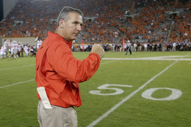 Ohio State head coach Urban Meyer celebrates during the closing moments of an NCAA college football game against Virginia Tech in Blacksburg, Va., Monday, Sept. 7, 2015. Ohio State won 42-24.  (AP Photo/Steve Helber)