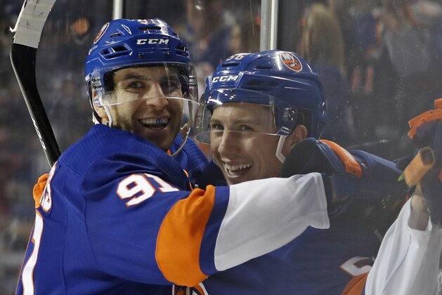 New York Islanders center John Tavares (91) celebrates with teammate Tanner Fritz (56) after Fritz scored his first career NHL goal during the second period of an NHL hockey game against the Minnesota Wild in New York, Monday, Feb. 19, 2018. (AP Photo/Kathy Willens)