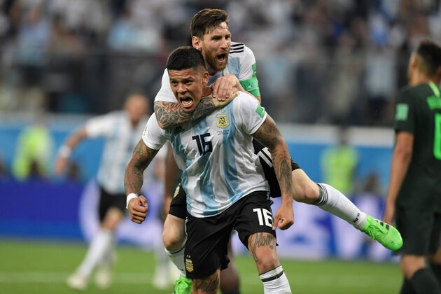 TOPSHOT - Argentina's defender Marcos Rojo (lower) celebrates his goal with Argentina's forward Lionel Messi during the Russia 2018 World Cup Group D football match between Nigeria and Argentina at the Saint Petersburg Stadium in Saint Petersburg on June 26, 2018. (Photo by GABRIEL BOUYS / AFP) / RESTRICTED TO EDITORIAL USE - NO MOBILE PUSH ALERTS/DOWNLOADS        (Photo credit should read GABRIEL BOUYS/AFP/Getty Images)