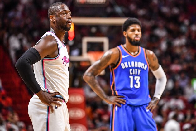 MIAMI, FL - APRIL 09: Dwyane Wade #3 of the Miami Heat and Paul George #13 of the Oklahoma City Thunder during a break in action in the game between the Miami Heat and the Oklahoma City Thunder at American Airlines Arena on April 9, 2018 in Miami, Florida.  NOTE TO USER: User expressly acknowledges and agrees that, by downloading and or using this photograph, User is consenting to the terms and conditions of the Getty Images License Agreement.  (Photo by B51/Mark Brown/Getty Images)