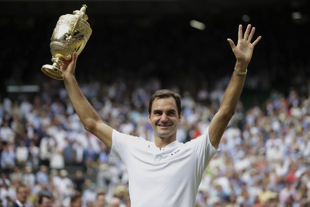 Switzerland's Roger Federer celebrates with the trophy after beating Croatia's Marin Cilic in the Men's Singles final match on day thirteen at the Wimbledon Tennis Championships in London Sunday, July 16, 2017. (Daniel Leal-Olivas/Pool Photo via AP)