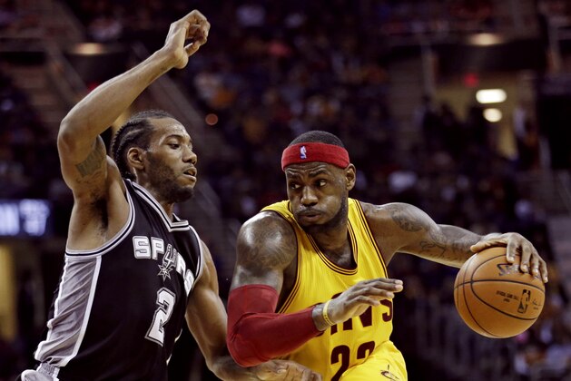 Cleveland Cavaliers' LeBron James (23) drives against San Antonio Spurs' Kawhi Leonard (2) during the third quarter of an NBA basketball game Wednesday, Nov. 19, 2014, in Cleveland. The Spurs defeated the Cavaliers 92-90. (AP Photo/Tony Dejak) Cleveland Cavaliers' LeBron James (23) drives against San Antonio Spurs' Kawhi Leonard (2) during the third quarter of an NBA basketball game Wednesday, Nov. 19, 2014, in Cleveland. The Spurs defeated the Cavaliers 92-90. (AP Photo/Tony Dejak)