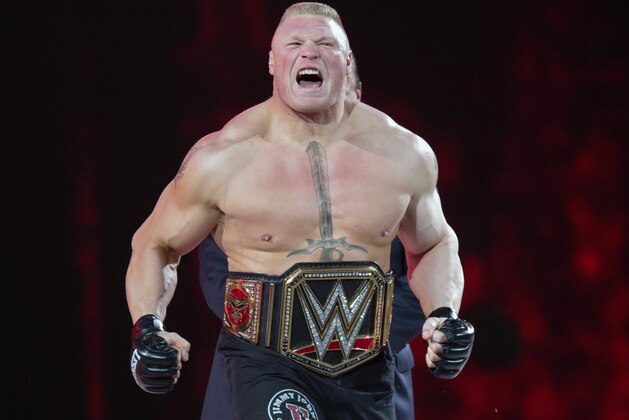 FILE - In this March 29, 2015, file photo, Brock Lesnar makes his entrance at Wrestlemania XXXI in Santa Clara, Calif. Lesnar, the former WWE and UFC heavyweight champion, was selected Monday, June 27, 2016, as the cover superstar for the WWE 2K17 video game that is set for an Oct. 11 release.  (AP Photo/Don Feria, File)