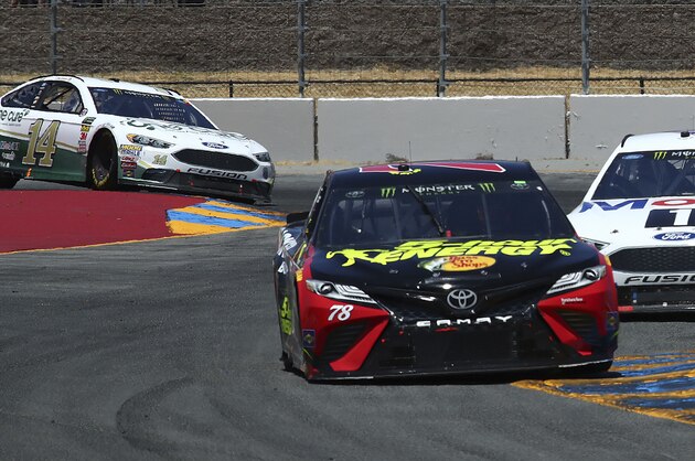 Martin Truex Jr. (78) leads Kevin Harvick (4) and Clint Bowyer, left, through a turn during a NASCAR Sprint Cup Series auto race Sunday, June 24, 2018, in Sonoma, Calif. Truex Jr. won the race, Harvick finished second and Bowyer was third. (AP Photo/Ben Margot)