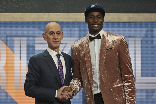 Jaren Jackson Jr. of Michigan State, right, poses with NBA Commissioner Adam Silver after he was picked fourth overall by the Memphis Grizzlies during the first round of the NBA basketball draft in New York, Thursday, June 21, 2018. (AP Photo/Kevin Hagen)