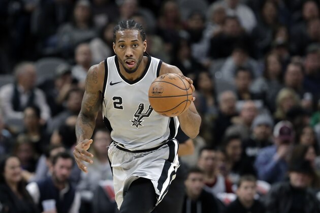 San Antonio Spurs forward Kawhi Leonard (2) moves the ball up court during the second half of an NBA basketball game against the Denver Nuggets, Saturday, Jan. 13, 2018, in San Antonio. San Antonio won 112-80. (AP Photo/Eric Gay)