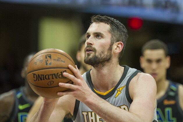 Cleveland Cavaliers' Kevin Love (0) shoots a foul shot against the Dallas Mavericks during the first half of an NBA basketball game in Cleveland, Sunday, April 1, 2018. (AP Photo/Phil Long)