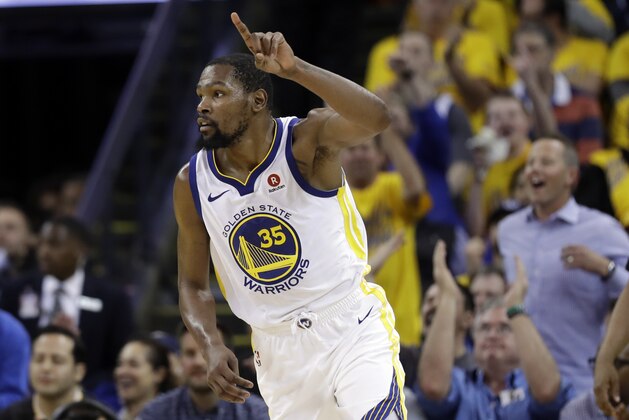 Golden State Warriors forward Kevin Durant reacts after scoring against the Cleveland Cavaliers during the second half of Game 1 of basketball's NBA Finals in Oakland, Calif., Thursday, May 31, 2018. (AP Photo/Marcio Jose Sanchez)