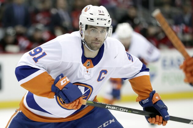 FILE - In this Saturday, March 31, 2018 file photo, New York Islanders center John Tavares skates against the New Jersey Devils during the first period of an NHL hockey game, in Newark, N.J. The NHL’s best rarely make it to free agency. Teams tend to re-sign their top players, keeping them off the market and on their rosters. That leaves a slew of solid veterans and journeymen available to the highest bidders trying to find a forward to play on a second or third line, a defenseman to be in a second pairing or perhaps a backup goaltender.(AP Photo/Julio Cortez, File)