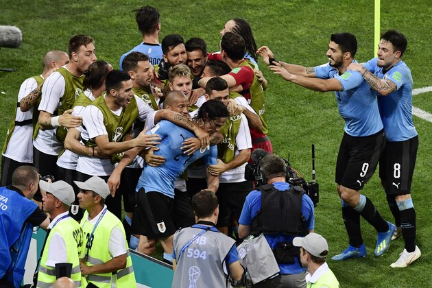 Uruguay's forward Edinson Cavani (C) celebrates with teammates after scoring a second goal during the Russia 2018 World Cup round of 16 football match between Uruguay and Portugal at the Fisht Stadium in Sochi on June 30, 2018. (Photo by PIERRE-PHILIPPE MARCOU / AFP) / RESTRICTED TO EDITORIAL USE - NO MOBILE PUSH ALERTS/DOWNLOADS        (Photo credit should read PIERRE-PHILIPPE MARCOU/AFP/Getty Images)