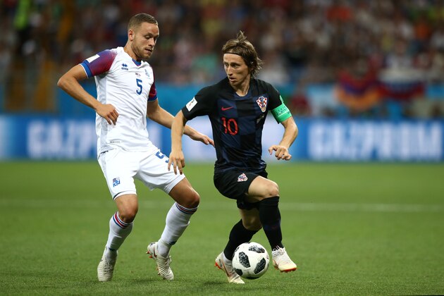 ROSTOV-ON-DON, RUSSIA - JUNE 26:  Luka Modric of Croatia controls the ball from Sverrir Ingason of Iceland during the 2018 FIFA World Cup Russia group D match between Iceland and Croatia at Rostov Arena on June 26, 2018 in Rostov-on-Don, Russia. (Photo by Jan Kruger/Getty Images)