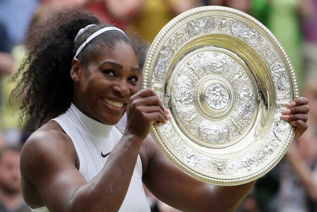 Serena Williams of the U.S holds up her trophy after beating Angelique Kerber of Germany in the women's singles final on day thirteen of the Wimbledon Tennis Championships in London, Saturday, July 9, 2016. (AP Photo/Tim Ireland)