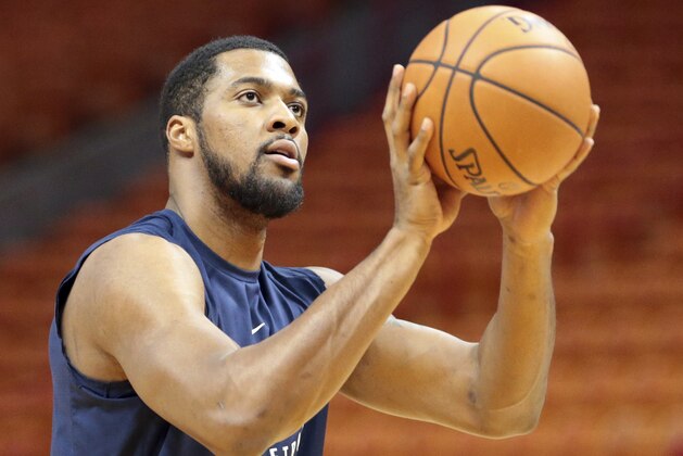 Utah Jazz forward Derrick Favors (15) warms up prior to an NBA basketball game against the Miami Heat, Sunday, Jan. 7, 2018, in Miami. (AP Photo/Joel Auerbach)